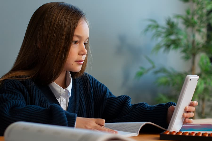 medium shot girl learning math school (1)