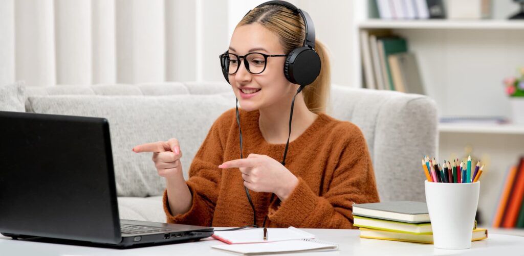 student online cute girl glasses sweater studying computer smiling (1) (1)